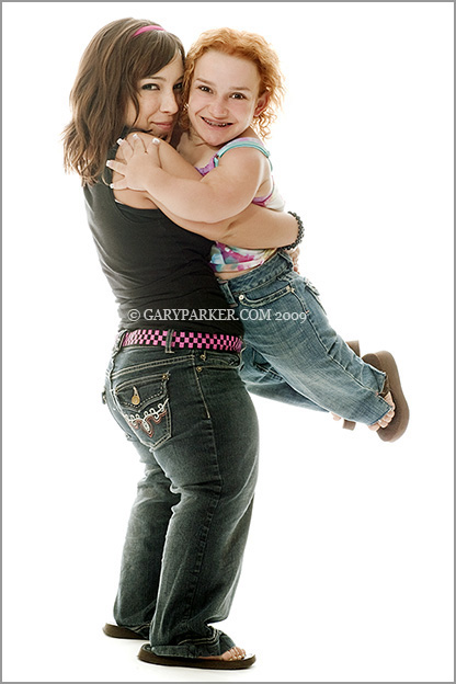 2'10" Cassee Cannata, Cartilage Hair Hypoplasia Dwarfism, gets a lift from friend Sara Zimmerman whose Pseudoachondroplastic Dwarfism makes her a compartively tall 4'.