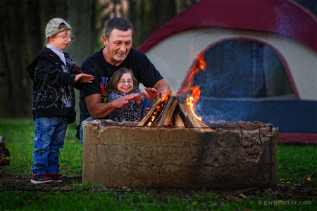 Scott Jordan, with his children Bri and  Brad Jordan, warm themselves during a camping trip. Primordial Dwarfism  